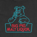 A close-up of a black t-shirt featuring a screen print of a cartoon pig and the text 'BIG PIG MALT LIQUOR' in red and light blue.